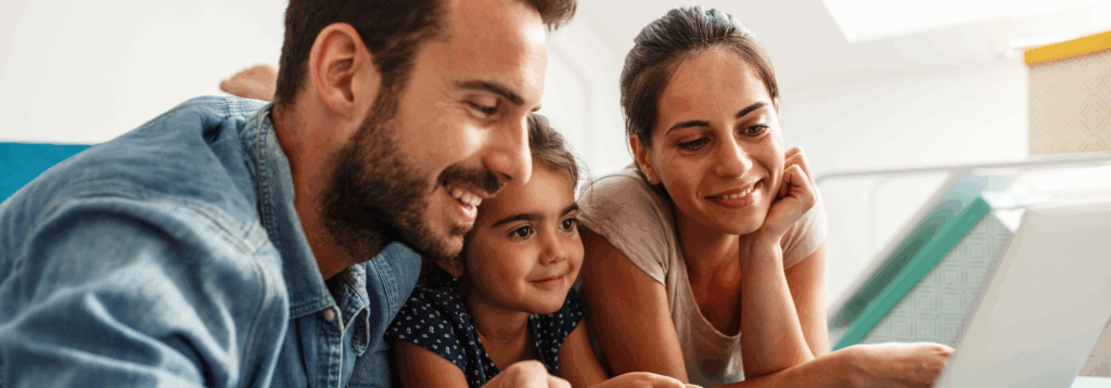 mother and father reading book with their young daughter